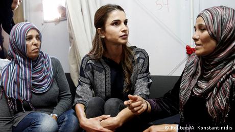 Queen Rania of Jordan, wearing no veil as she speaks with women wearing hijab at a refugee facility in Greece. (Reuters/A. Konstantinidis)