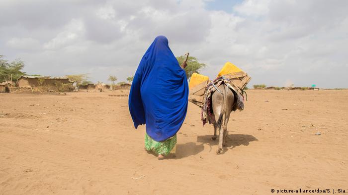 A woman walkingin the desert in Ethiopia
