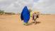 A woman walkingin the desert in Ethiopia A woman walkingin the desert in Ethiopia