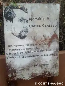 Panel showing text and portrait of Carlos Cardoso