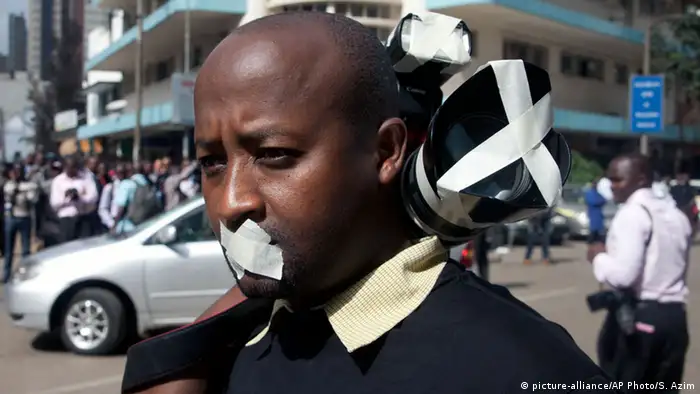 Protester with tape over his mouth