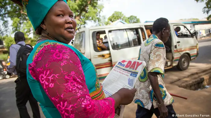 woman with newspaper in South Sudan