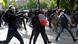 Masked youths hurl projectiles at police during a demonstration against a French labor law amendment. Masked youths hurl projectiles at police during a demonstration against a French labor law amendment.