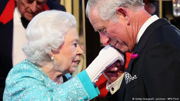 Queen Elizabeth II and King Charles III, who kisses her gloved hand