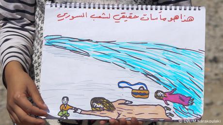 A refugee girl holding a painting (photo: Marianna Karakoulaki)