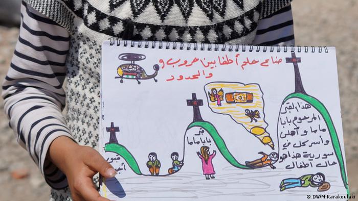 A refugee girl holding a painting (photo: Marianna Karakoulaki)