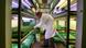 A lab worker tends to genetically modified plants. A lab worker tends to genetically modified plants.