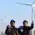 Chinese technicians inspect wind turbines at a wind farm in Tianchang city, China