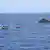 Перевернутая лодка с беженцами, вышедшая из ливийского порта