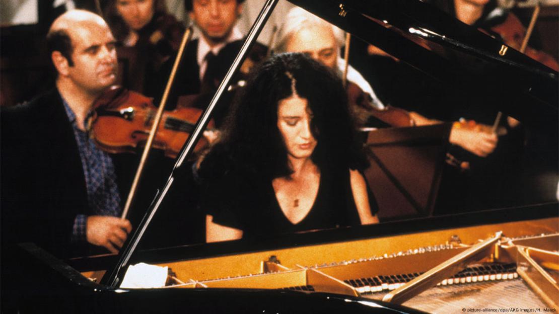 Martha Argerich performs in 1982 at the piano with an orchestra behind her