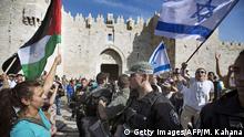 17.5.2015*** Israeli policemen (C) separate young Israelis holding national flags (R) and Palestinian protestors with their national flags (L) on May 8, 2013 in the Damascus gate in Jerusalem's Old City, as Israelis celebrate Jerusalem Day which marks the anniversary of the 'reunification' of the city after Israel captured the Arab eastern sector from Jordan. Thousands of Israelis joined marches and rallies throughout the city, including a 'flag march' that passed through Damascus Gate on its way to the Western Wall. Police, who were deployed in their thousands, arrested 13 people including two 'Arab youths' suspected of throwing water at Jews participating in the flag dance near Damascus Gate, police spokeswoman Luba Samri said in a statement. AFP PHOTO/MENAHEM KAHANA (Photo credit should read MENAHEM KAHANA/AFP/Getty Images) Getty Images/AFP/M. Kahana