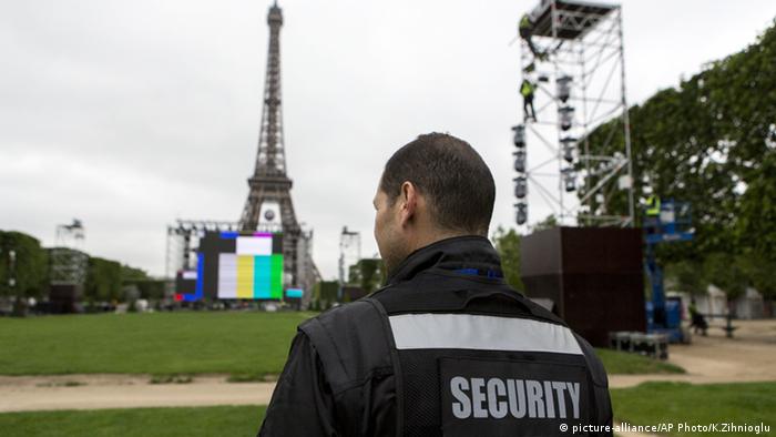 Сотрудник сил безопасности перед фан-зоной в Париже