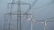 Electricity pylons carry high-voltage cables near wind turbines near Freiwalde, Germany Electricity pylons carry high-voltage cables near wind turbines near Freiwalde, Germany