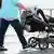 Parents push a baby in a pram