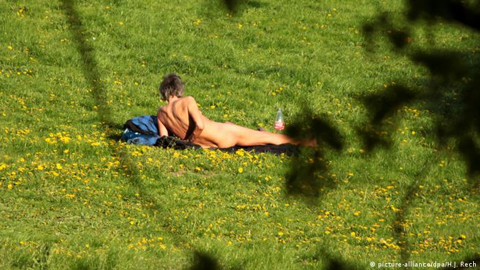 a naked person lying in a park