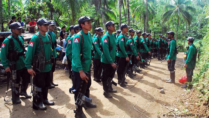 Soldiers of the New People's Army (NPA) make a formation