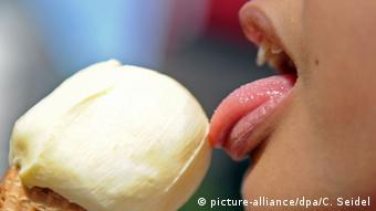 A closeup of someone licking an ice cream cone