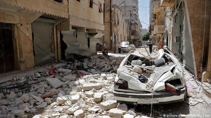 A damaged vehicle is seen on the debris of buildings after a warcraft belonging to the Russian army carried out an attack in Aleppo, Syria