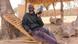 Seydou Ilboudo sits in a wooden chair and listens to the radio Seydou Ilboudo sits in a wooden chair and listens to the radio