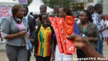 February 14, 2014 An Aids Healthcare Foundation-Kenya worker distributes condoms in the streets of Nairobi on February 14, 2014 to promote safe sex practices during the Valentine week and to mark the International Condom Day. A non-governmental organisation is planning to test at least 5,000 people for HIV-Aids and distribute 200,000 condoms over the valentine weekend. AFP PHOTO/SIMON MAINA (c) Getty Images/AFP/S. Maina