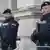 Two Austrian police officers guard a Vienna courthouse during a high-profile trial in 2016
