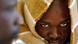 close up shot of an African man, with his head wrapped in a blanket close up shot of an African man, with his head wrapped in a blanket