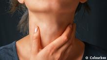 Unrecognizable woman holds her throat, sore throat