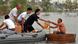 Volunteers giving food supplies to a villager in a makeshift boat on flood water, Xinhua Village of Xinchang county in Wuhan city, Hubei Province of central China on 18 July 2016 (Photo: picture-alliance/dpa) Volunteers giving food supplies to a villager in a makeshift boat on flood water, Xinhua Village of Xinchang county in Wuhan city, Hubei Province of central China on 18 July 2016 (Photo: picture-alliance/dpa)