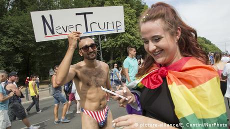 A reveler carries a sign at the CSD parade that reads: Never Trump