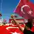 A man waves Turkey's national flag as supporters of various political parties gather in Istanbul's Taksim Square