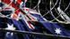 A symbolic image of an Australian flag behing razor wire A symbolic image of an Australian flag behing razor wire