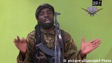 FILE - In this May 12, 2014 file image from video by Nigeria's Boko Haram terrorist network shows their leader Abubakar Shekau speaks to the camera. The leader of Nigeria¿s Islamic extremist group Boko Haram denied agreeing to any cease-fire with the government and said more than 200 kidnapped schoolgirls all have converted to Islam and been married off. In a new video released late Friday, Oct. 31, 2014, Abubakar Shekau dashed hopes for a prisoner exchange to get the girls released. ¿The issue of the girls is long forgotten because I have long ago married them off,¿ he said, laughing. ¿In this war, there is no going back.¿ (AP Photo/File) | © picture-alliance/AP Photo