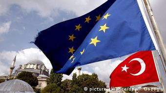 A tattered EU flag and a Turkish flag wave in front of the Hagia Sophia in Istanbul