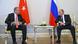 Sitting, Turkish President Recep Tayyip Erdogan talks with Russian President Vladimir Putin, with their respective flags behind them. Sitting, Turkish President Recep Tayyip Erdogan talks with Russian President Vladimir Putin, with their respective flags behind them.