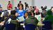 Eine Helferin mit Flüchtlingen in einer Messehalle in Erfurt (Foto: picture-alliance/dpa/M. Schutt) Eine Helferin mit Flüchtlingen in einer Messehalle in Erfurt (Foto: picture-alliance/dpa/M. Schutt)