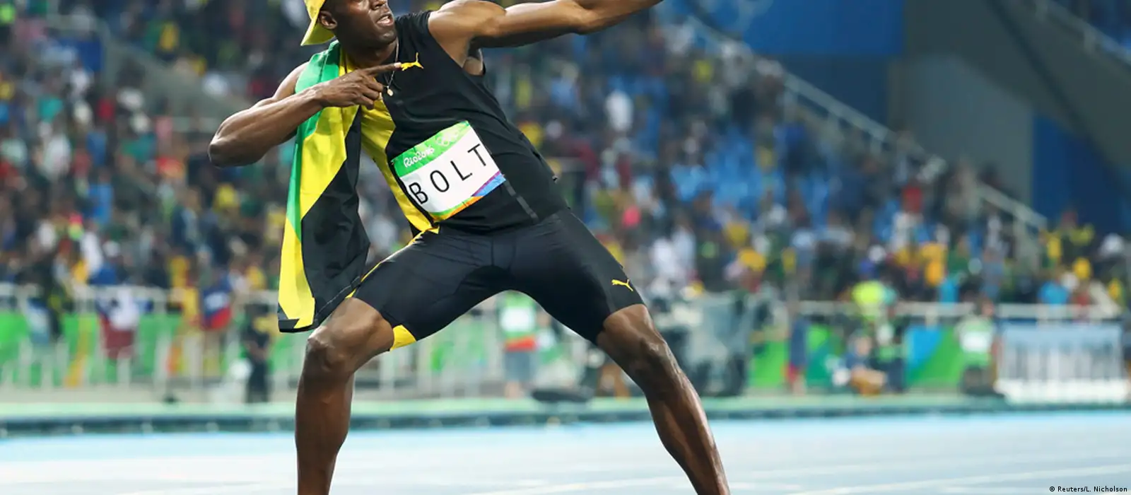 Usain Bolt of Jamaica strikes a pose during the victory ceremony for the  Men's 200M Final