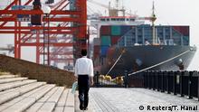 October 20, 2015 A man walks near a container ship at a port in Tokyo, Japan, October 20, 2015. REUTERS/Toru Hanai/File photo (c) Reuters/T. Hanai
