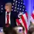 Trump gives campaign speech with three AMerican flags behind him.