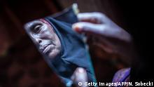 ARCHIV 2014 +++++ Amran Mahamood, who has made a living for 15 years by circumcising young girls, looks into a piece of a mirror on February 19, 2014 in Hargeysa. The centuries old tradition of female circumcision, also known as female genital mutilation (FGM), is on the decline in northern Somalia, though it continues to have some of the highest rates of women who have undergone the practice in the world. Copyright: Getty Images/AFP/N. Sobecki