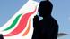 A man in silhouette prays with the tail of a Sri Lankan Airline Airbus A320 in the background A man in silhouette prays with the tail of a Sri Lankan Airline Airbus A320 in the background