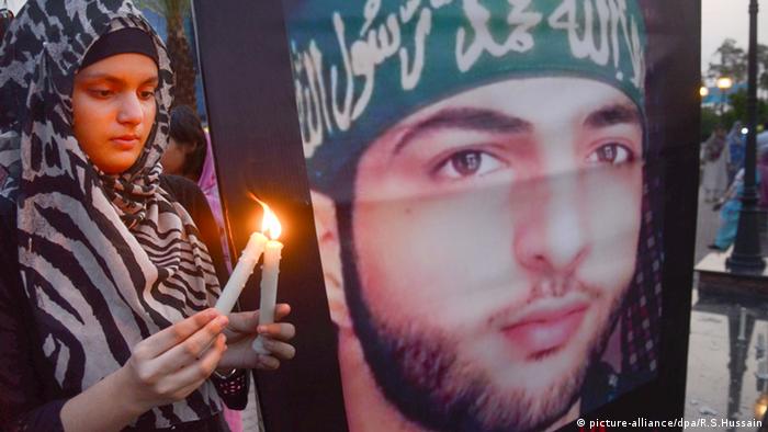 A Pakistani girl lights a candle to show solidarity with Burhan Wani