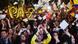 Colombians celebrate as they watch the signing of a peace agreement on a giant screen TV. Colombians celebrate as they watch the signing of a peace agreement on a giant screen TV.