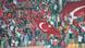 Fans wave Turkish flags during football game. Fans wave Turkish flags during football game.