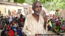 This photo taken on June 30, 2016 shows a displaced malnurished father speaking as he seeks for help in Bama's camp for internally displaced people (IDP), in the outskirts of Maiduguri capital of Borno State, northeastern Nigeria. Medical charity Doctors Without Borders (MSF) last week warned 'a catastrophic humanitarian emergency' was unfolding at the camp for internally displaced people (IDP) in Bama. At least 188 people died between May 23 and June 22, mainly from diarrhea and malnutrition, while more than 1,200 graves, many of them for children, had been dug near the camp in the last year, it added. / AFP / STRINGER (Photo credit should read STRINGER/AFP/Getty Images) Getty Images/AFP/Stringer