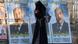A Jordanian veiled woman uses her mobile phone as she walks next to election campaign posters in Amman, Jordan (photo: picture-alliance/dpa/J. Nasrallah) A Jordanian veiled woman uses her mobile phone as she walks next to election campaign posters in Amman, Jordan (photo: picture-alliance/dpa/J. Nasrallah)