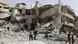 People comb through the rubble of a partiially collapsed three-story building in Aleppo People comb through the rubble of a partiially collapsed three-story building in Aleppo