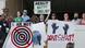 People hold signs at a "protest for justice" over Friday's shooting death of Terence Crutcher People hold signs at a "protest for justice" over Friday's shooting death of Terence Crutcher