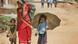Nepalese woman walking down the road with two kids Nepalese woman walking down the road with two kids