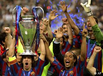 Barcelona's Carles Puyol lifts the trophy after his team beat Arsenal