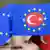 EU flags with the Turkish crescent and star inside the EU star circle.